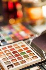 Table details from professional makeup artist studio. Close up shot on make up color palette.