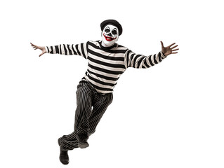 mime performing a funny routine walking against the wind in black and white striped costume on isolated background 