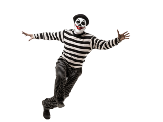 mime performing a funny routine walking against the wind in black and white striped costume on isolated background
