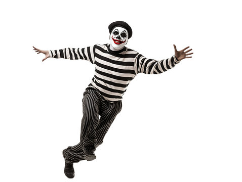 mime performing a funny routine walking against the wind in black and white striped costume on isolated background
