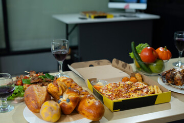 Asian business team are excited business success with inspiration from their excellent financial results, celebration successful deal with champagne and pizza in the workplace.