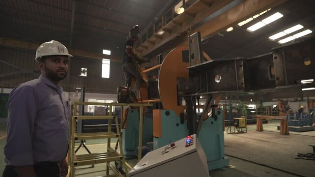 worker in factory operating heavy machinary 