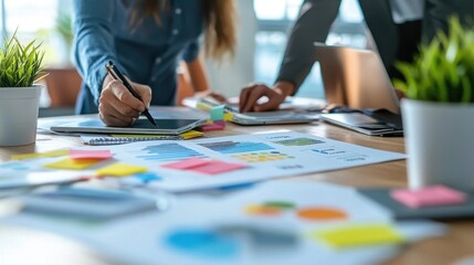 Collaborative Coworkers Brainstorming Ideas with Notebooks and Laptops in Modern Workspace