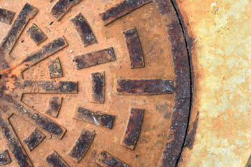 Rusty metal circle manhole cover close up shot
