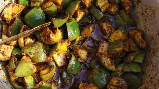 Making of Indian  Spicy Mango Pickle with Condiments Like Black Cumin, Chilli Powder, Cumin Seed, Fenugreek, Fennel and Oil