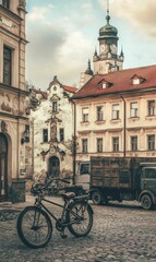 Old town street with bicycle, truck and clock tower.