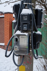 Electric meters for household consumers in private homes hang on a pole