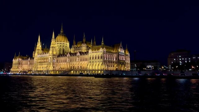 Video of a hungarian parliament building illuminated at night by the Danube River