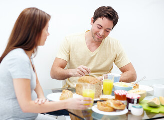 Pregnant woman, eating or happy couple in home with breakfast for healthy diet or nutrition. Food, wellness or people enjoying meal with pregnancy, smile or prenatal health in morning at family house