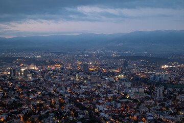 City illuminated at dusk, seen from above. The European capital of North Macedonia, Skopje.