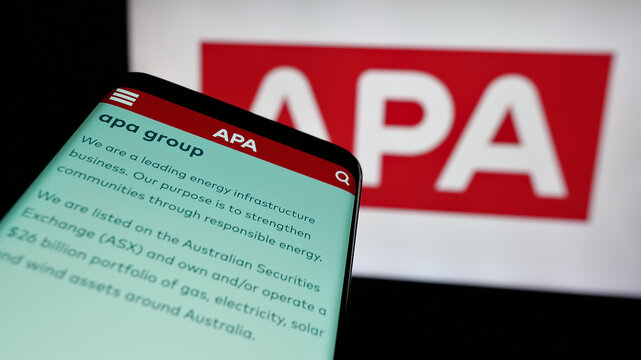 Stuttgart, Germany - 10-14-2024: Mobile phone with website of Australian natural gas company APA Group on screen in front of business logo. Focus on top-left of phone display.