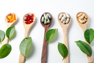 Vitamin capsules in a wooden spoon, soft gels, Fish oil capsules, omega 3, omega 9, vitamin D, vitamin E
