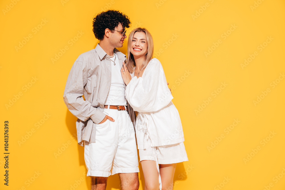 Canvas Prints Happy beautiful romantic teenage couple. Smiling handsome caucasian man and young woman in summer clothes posing in studio, hugging sharing emotions, cheerful and happy. Isolated on yellow