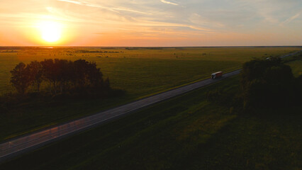 cars and trucks are driving along the highway