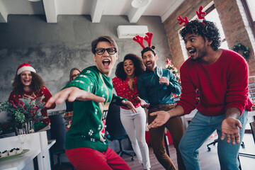 Portrait of group friends colleagues rejoice dance drink champagne christmas party loft office...