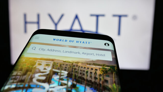 Stuttgart, Germany - 10-16-2024: Smartphone with website of US hospitality company Hyatt Hotels Corporation on screen in front of logo. Focus on top-left of phone display.