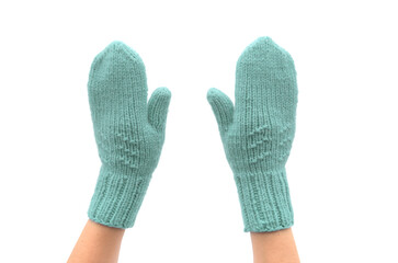 green knitted mittens on hands