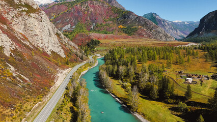 autumn mountain Altai, a road in the mountains along which cars are traveling