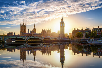 The Westminster Palace and Big Ben clocktower in London, England, during a beautiful sunset with...
