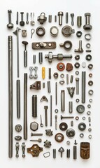 Obraz premium Assortment of metal hardware arranged on white.