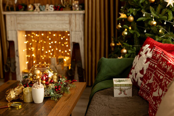 Beautiful room decorated for Christmas with fireplace, couch and table, lights, candles and decoration