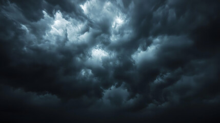 Obraz premium A dark black sky filled with ominous and scary clouds, creating a dramatic and atmospheric scene. The stormy clouds create an eerie