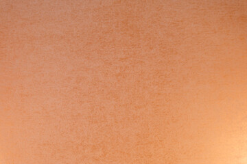 光の透けたざらざらした羊皮紙のテクスチャー背景素材　オレンジのアンティーク素材　透けた壁紙