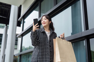 Joyful Shopper Celebrates Black Friday Deals with Smartphone