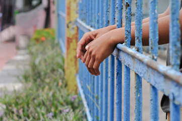 close up of prisoner hands in jail background.