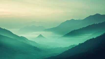 Fototapeta premium Misty mountains at sunrise, with a soft green hue, creating a serene and tranquil scene.