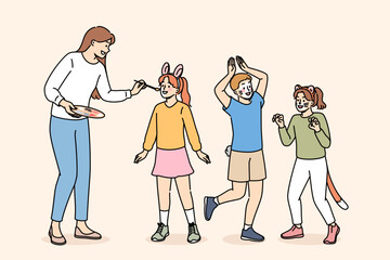 Children party dedicated to animals, with face painting for boys and girls from caring woman artist. Happy children rejoice with painted faces for themed party or masquerade on eve of animal day