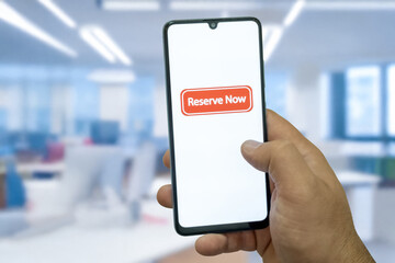 “Reserved” message on close-up smartphone screen. Online reservation. Office background. Hotel, vacation or event booking message. 