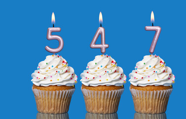 Birthday Cupcakes With Candles Lit Forming The Number 547