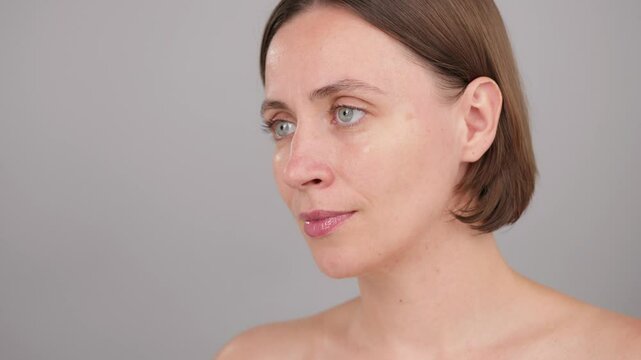 Skincare, Eye Patches and Brunette Woman in studio for cosmetics. Shining effect after application. Facial treatment and collagen glow. Spa, aesthetic and detox. Portrait of person on grey background.