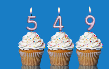 Birthday Cupcakes With Candles Lit Forming The Number 549