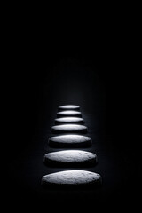 Fototapeta premium Illuminated stepping stones on a dark background