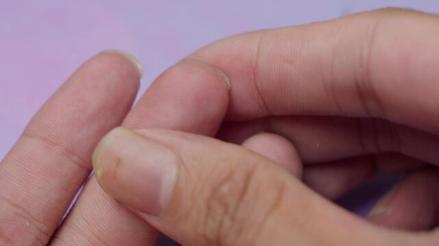 Poking their finger to obtain a blood sample