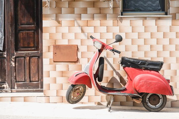 vintage scooter parked on the street © Olga Angelucci