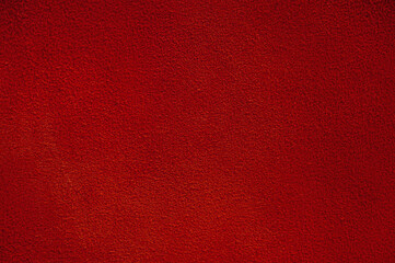Red suede texture macro photo as background.