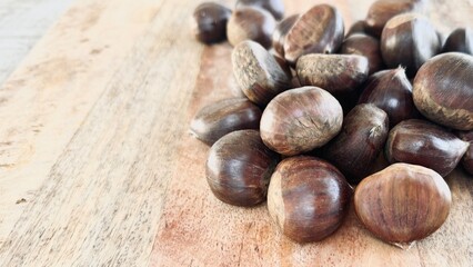 Chestnuts on the table freshly harvested from the forest.
