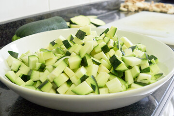 Pile of zucchini cut in a deep plate