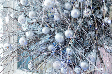 Christmas decorations. Christmas composition in the interior: silver balls on branches.