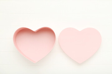 Heart shaped gift box on white wooden table