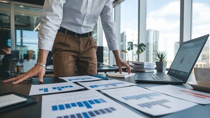 Office worker preparing for a client presentation with printed slides and notes