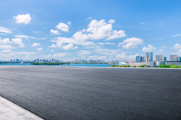 Fototapeta premium Empty asphalt road and cityscape with skyline in modern city
