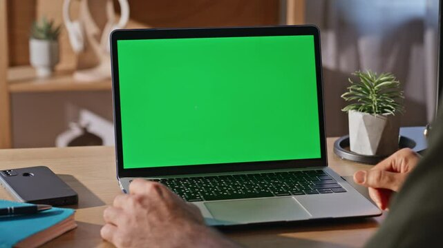 Guy using touchpad chromakey laptop at desk closeup. Businessman surfing online