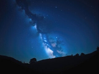 Milky way galaxy shining over mountain landscape