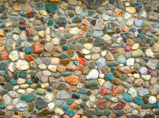 Multicolored bright wall of stones. Facade of stone and mortar