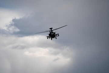 close-up of a British army Boeing Apache Attack helicopter gunship AH64E AH-64E ArmyAirCorp in low level overhead flight