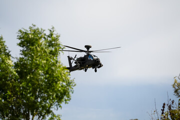 close-up front quarter view of a British army Boeing Apache Attack helicopter gunship AH64E AH-64E ArmyAirCorp in low level flight